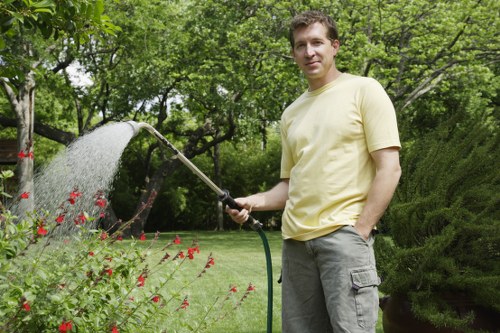 Gardener reviewing a service concern in a garden setting